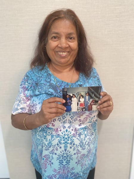 Pushpa holding a photo of her Family, Sister and Mother when they first arrived in Melbourne