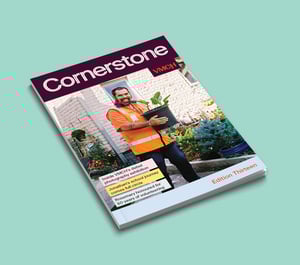 VMCH’s Cornerstone magazine cover showing a smiling man in a high-vis vest holding a potted plant, standing in a garden.