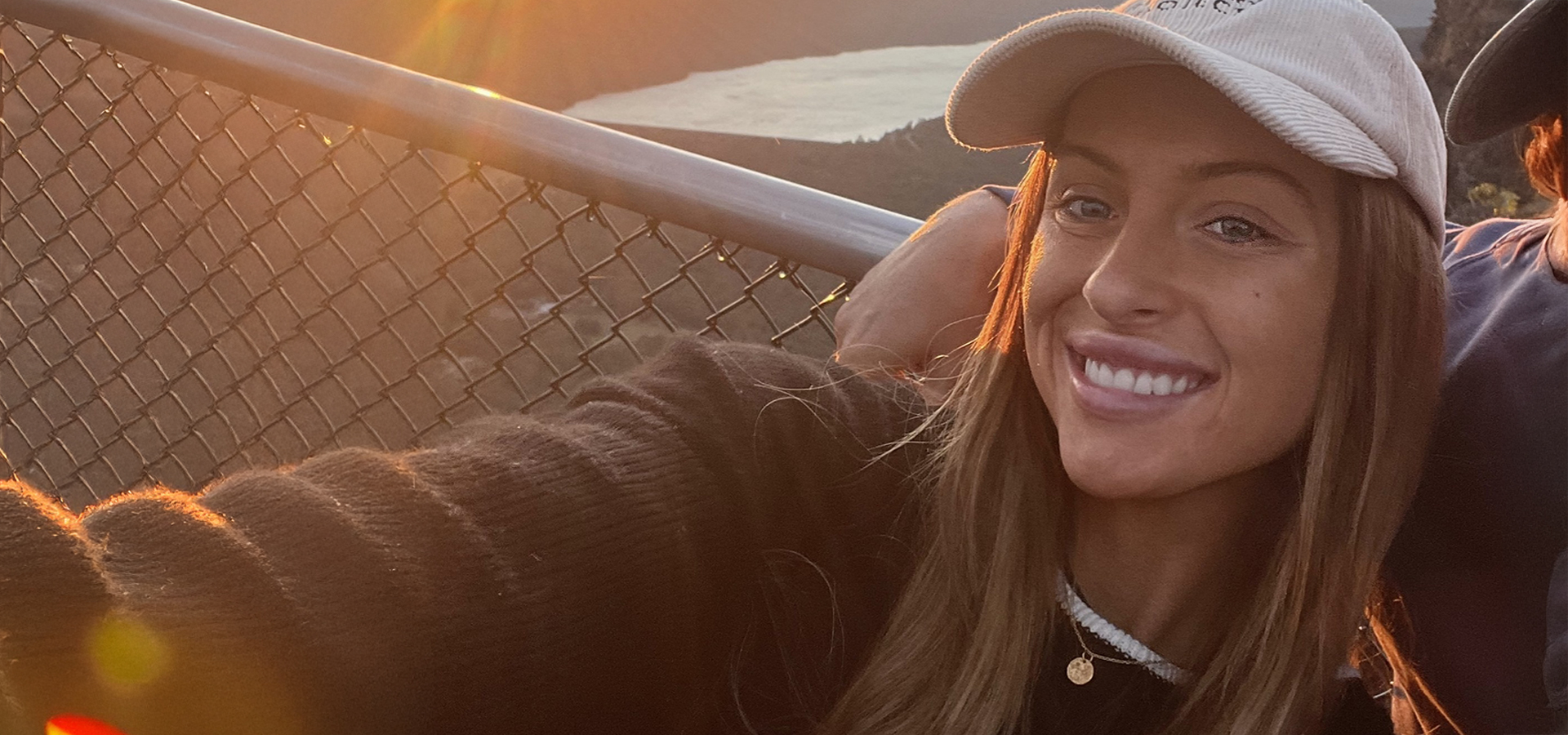 A woman wearing a hat takes a selfie