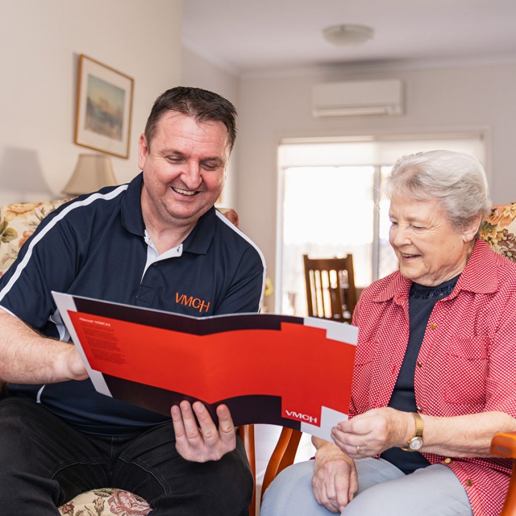 A care worker explaining care management services to his client.