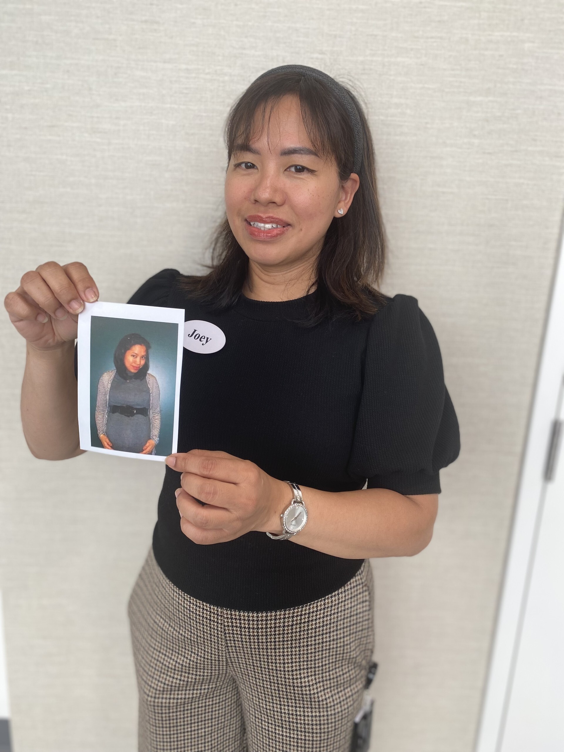 Lifestyle Coordinator Joey holds a photograph of herself when she was pregnant