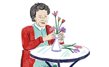 A woman organising a floral arrangement